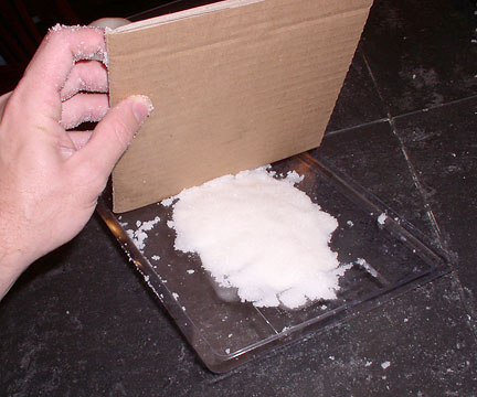 Raking off excess sugar from the calaveras mold